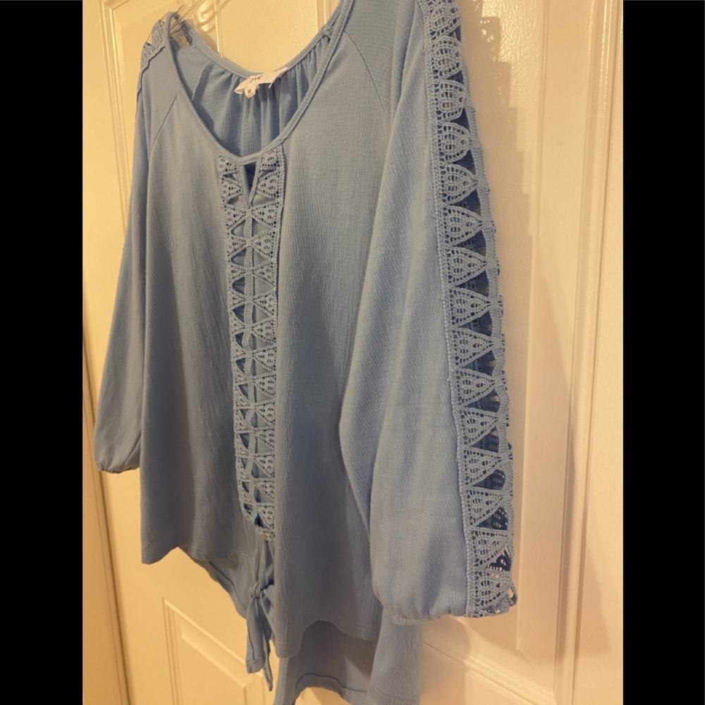 Pretty blue 3/4 sleeve top. Very feminine detail on sleeves. Tie front.